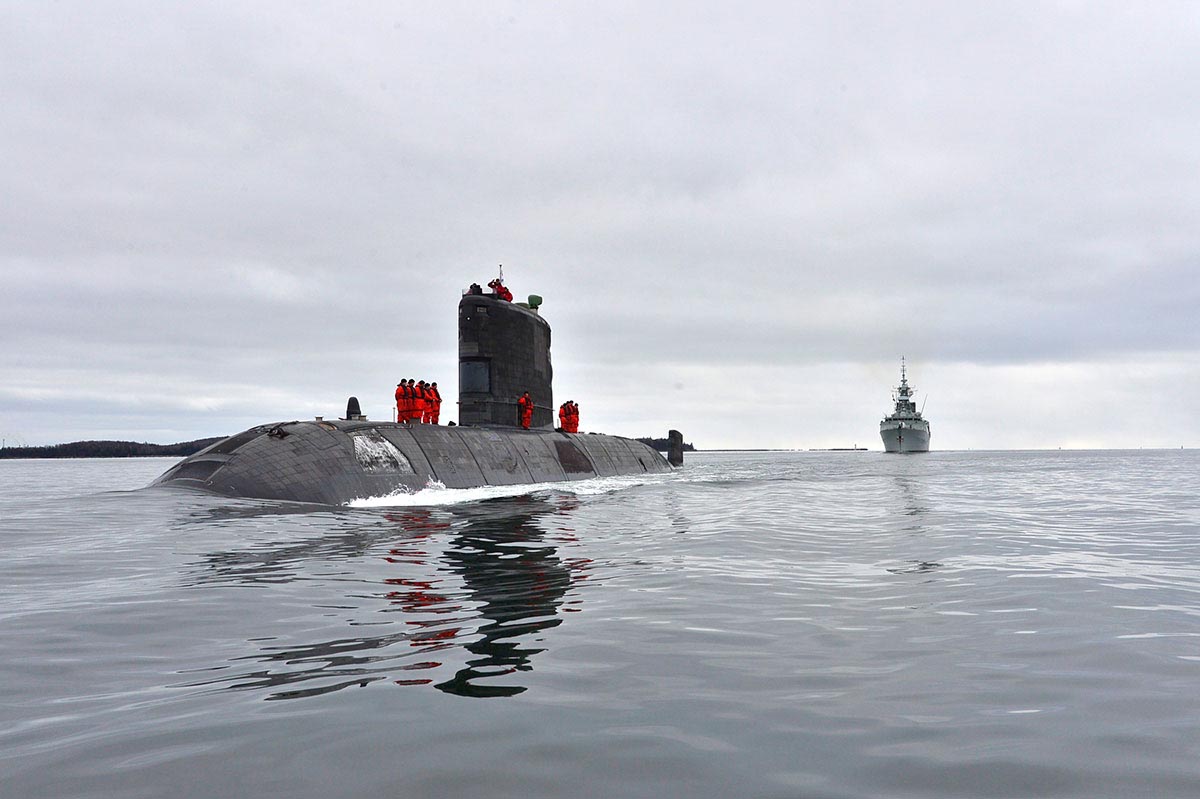 HMCS WINDSOR entering Halifax harbour, followed by a Canadian Patrol Frigate.