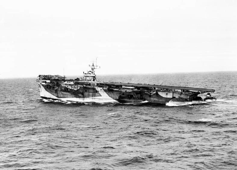 The damaged HMS NABOB proceeding homewards under her own steam, her stern low down in the water. She was hit by a torpedo during an operation in northern waters. Despite her damaged condition, NABOB turned homeward with a skeleton crew and reached her base after sailing 1070 miles at a steady ten knots. (RN Photo)
